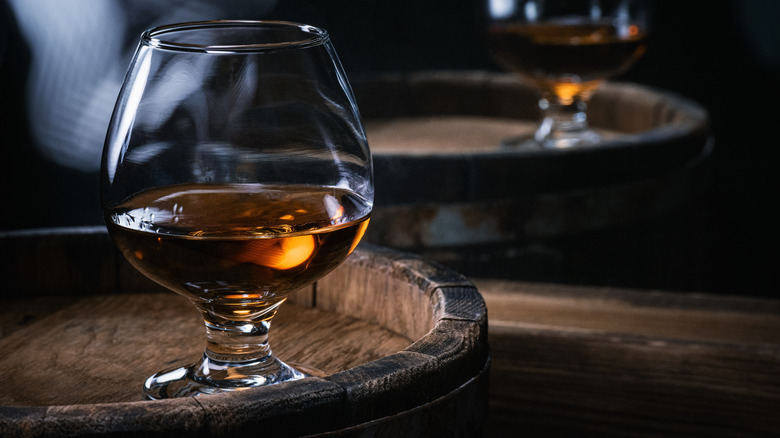 Cognac brandy glass on barrel