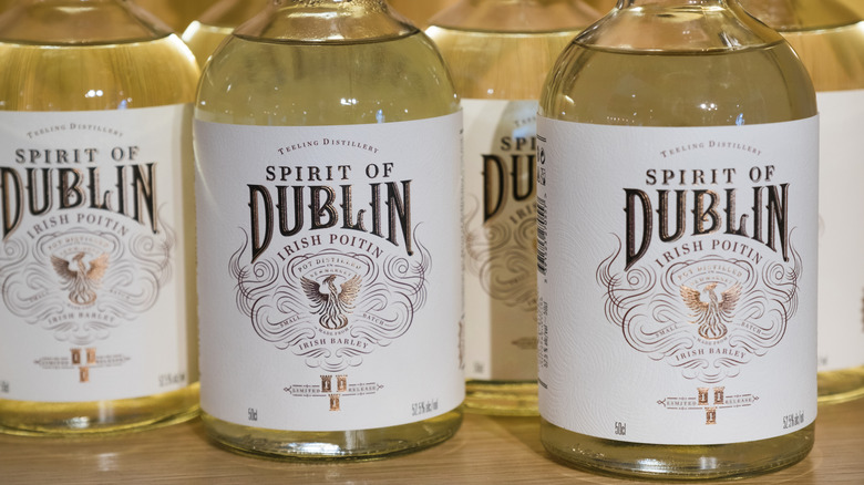 Irish poitin bottles on shelf.