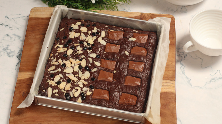 freshly baked brownies in a parchment-lined square baking pan