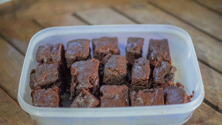 brownies squares arranged in a plastic container