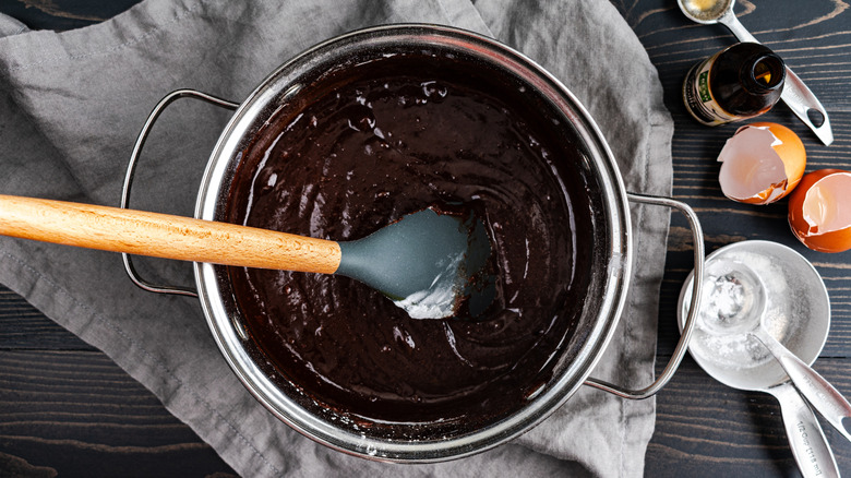 overhead shot of brownie batter in a pot with a spatula