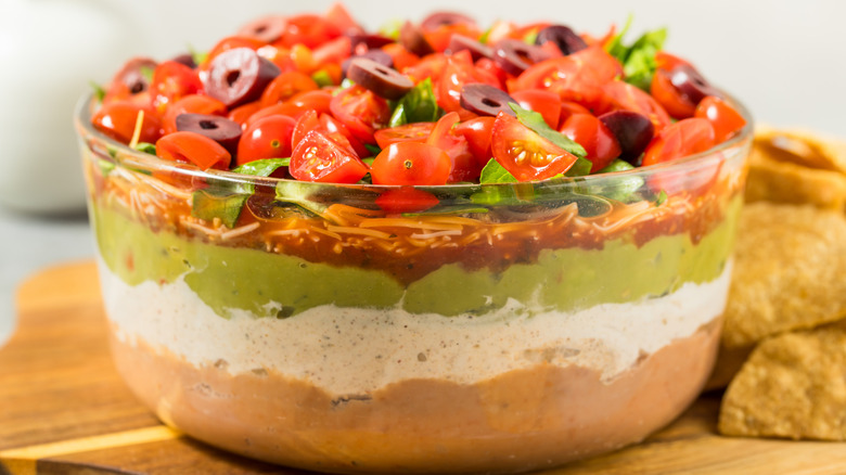 Mexican seven layer dip in glass bowl