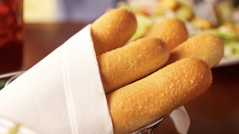 Basket of Olive Garden breadsticks wrapped in cloth