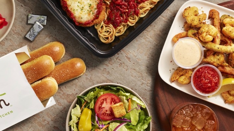 Assortment of Olive Garden items including breadsticks, salad, and Shrimp Fritto Misto