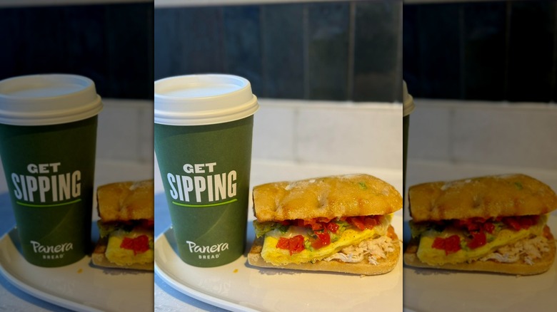 Panera Bread breakfast sandwich next to takeout hot drink