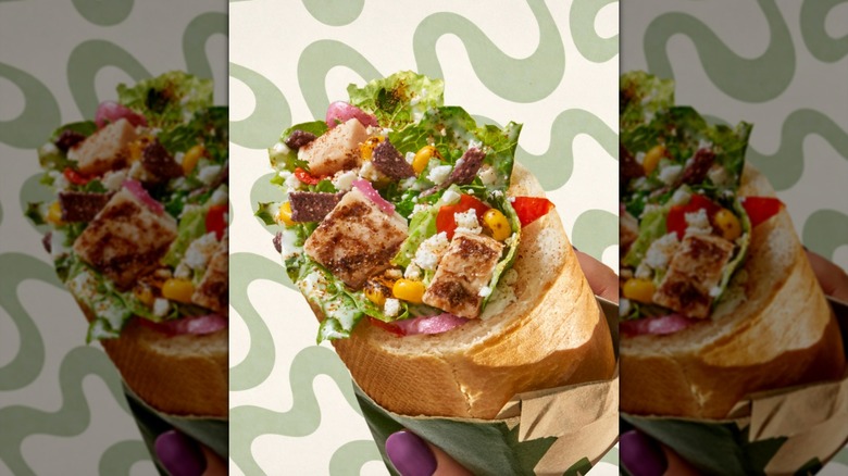 Panera Bread Salad Stuffer Sandwich superimposed on green wavy background