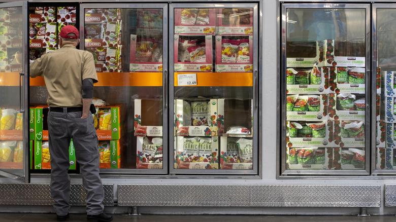 Costco member browses the freezer section