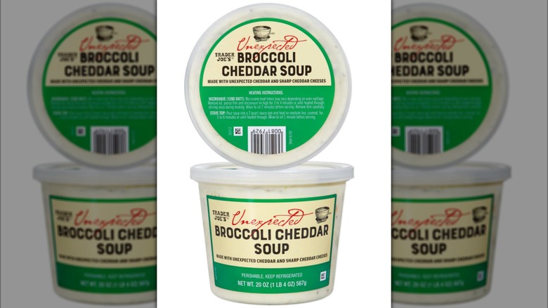 View of a container of broccoli cheddar soup with white background