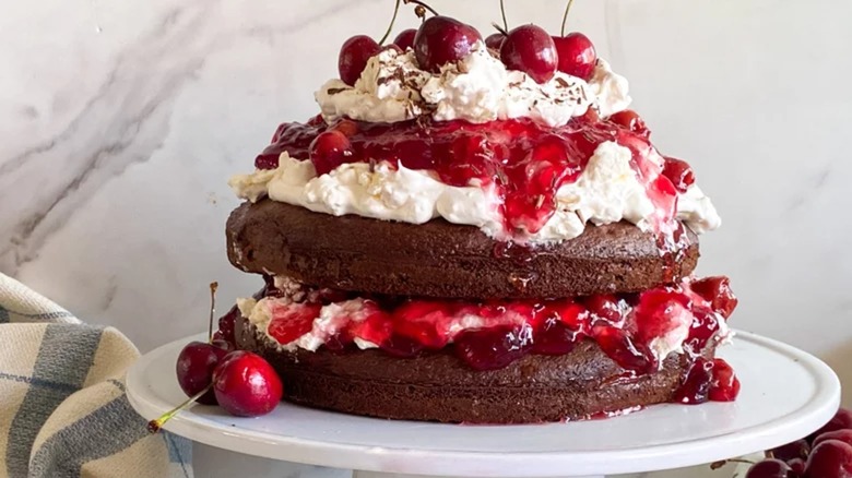 Black forest cake with lots of whipped cream and cherries