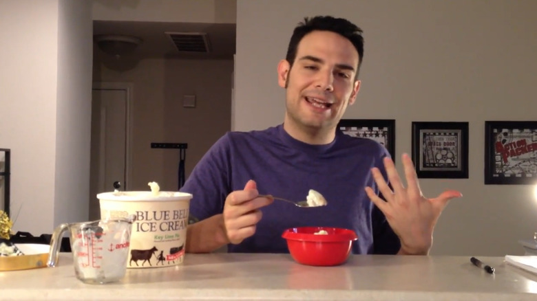 Person sitting at table eating from bowl of Blue Bell key lime pie ice cream