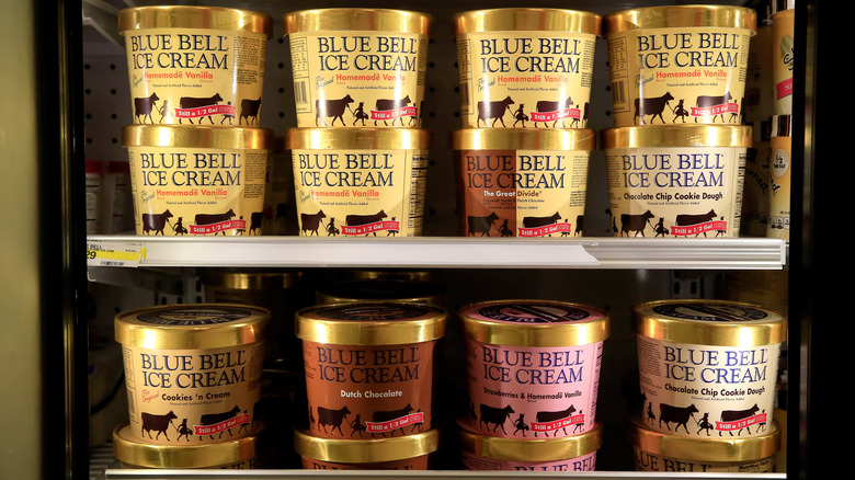 Cartons of blue bell ice cream in freezer with glass door