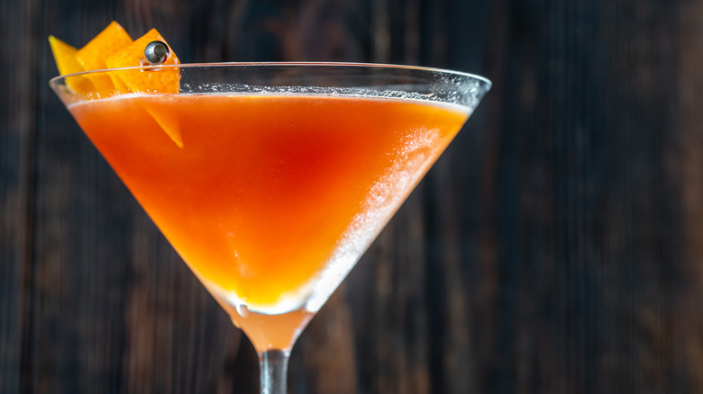 Close up of a blood and sand cocktail in a coupe