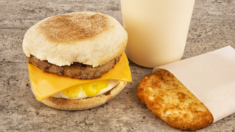 Fast food breakfast sandwich with hashbrown and drink
