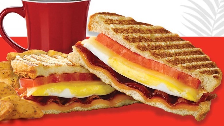 Wendy's Mornin' Melt Panini with potatoes and coffee cup in the background