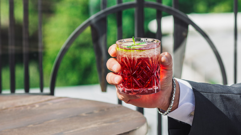 Person holding cherry lime spritz