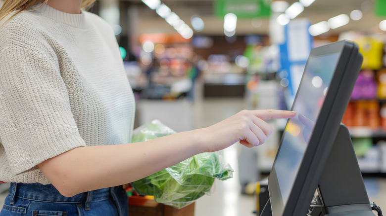 Woman checking out at self checkout