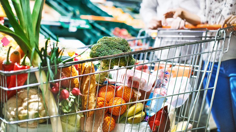 Overflowing cartload of produce in grocery cart