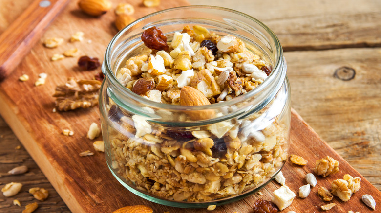 Granola with nuts and dried fruit in a glass jar