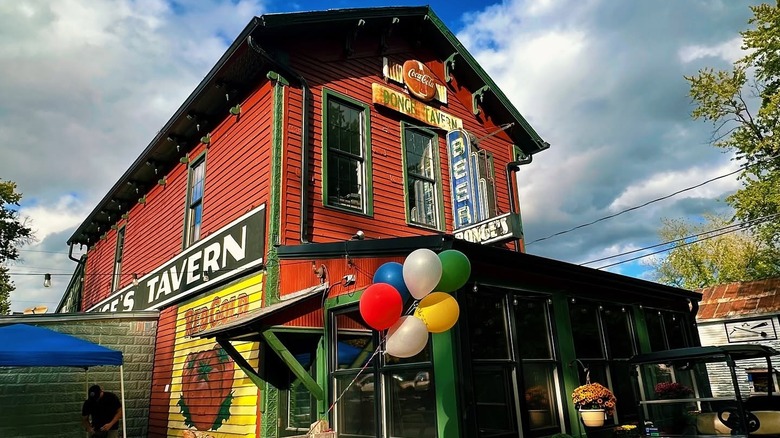 Balloons float in the foreground in an exterior shot of Bonge's Tavern