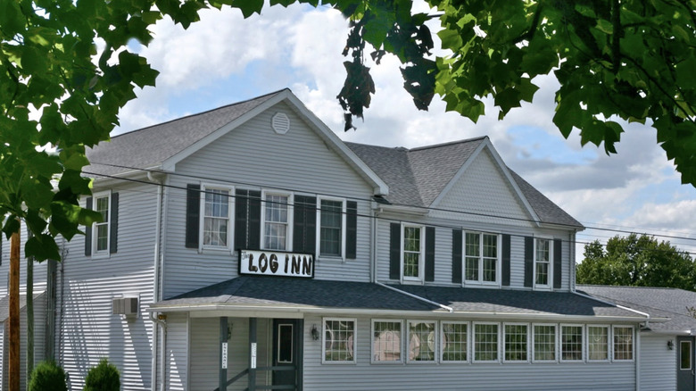 View of the Log Inn from beneath a tree branch