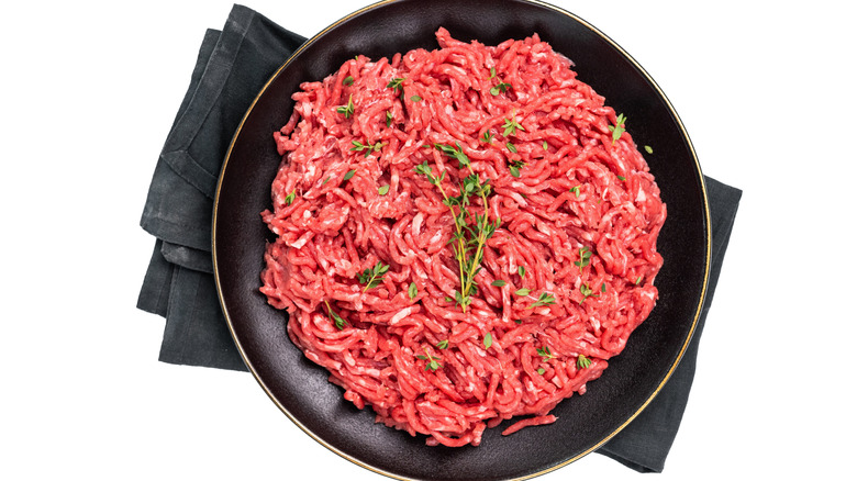 Raw ground lamb in black bowl