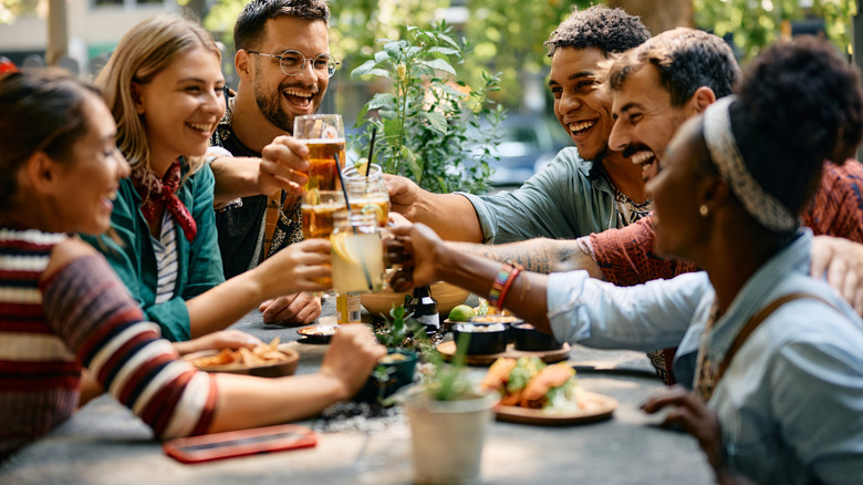 Group of friends laughing at a table in restaurant