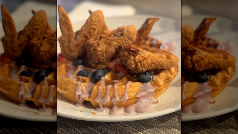fried chicken with berry waffles on a plate