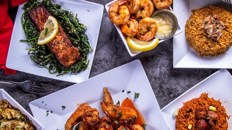 Aerial view of assortment of dishes inclding shrimp, rice, and fish