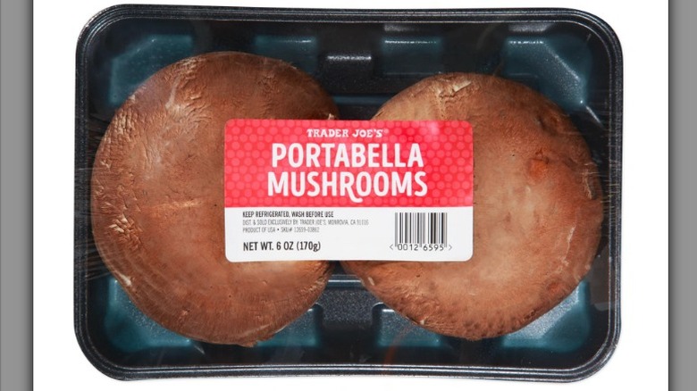 Portabella mushrooms in a package on white background