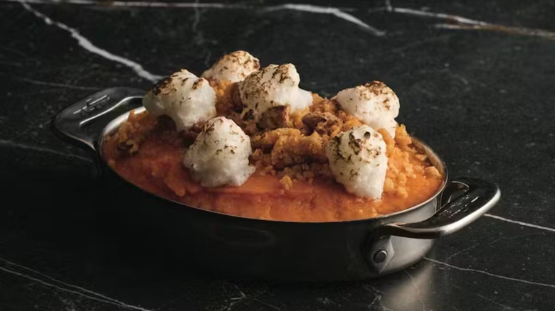 Sweet potato casserole in a dark double handled vessel