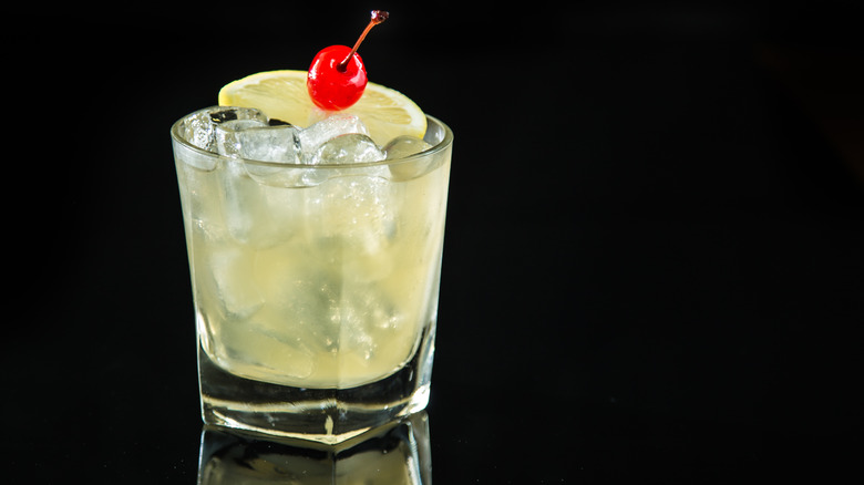 Amaretto sour cocktail against a black background