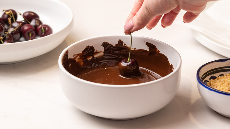 dipping a cherry in chocolate