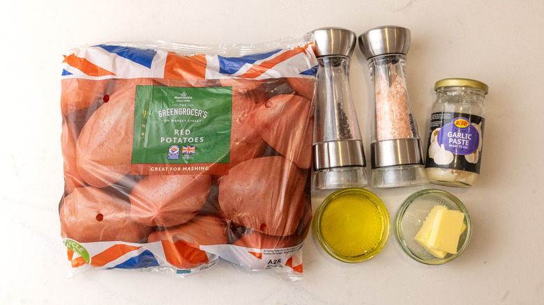 bag of red potatoes, jar of garlic paste, and other air-fried garlic smashed potatoes ingredients laid out