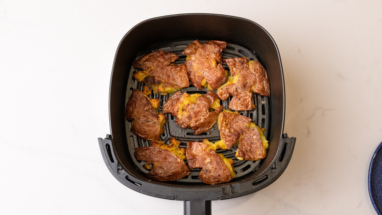 air-fried smashed potatoes in air fryer basket