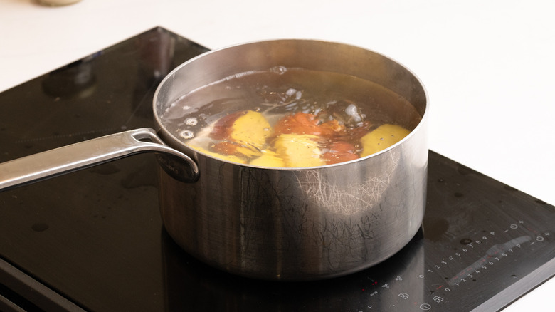 chopped red potatoes boiling in in saucepan on the stove