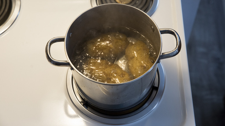 potatoes boiling in medium pot