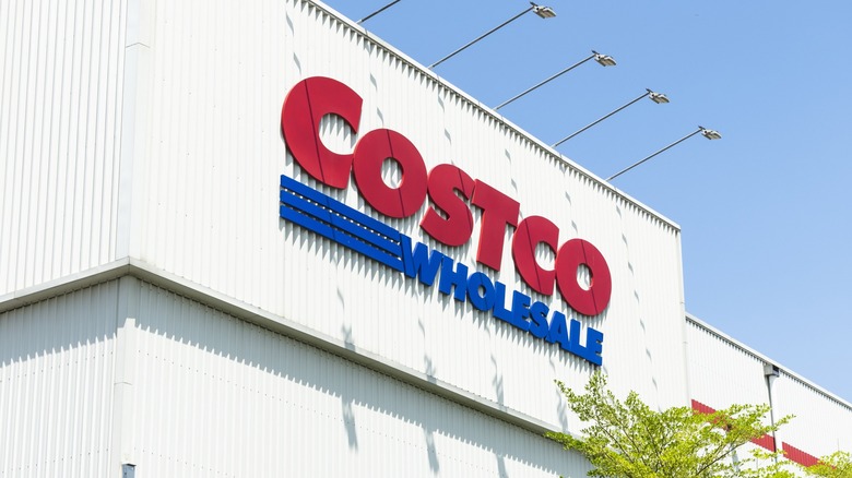 Close-up of a Costco storefront with blue sky