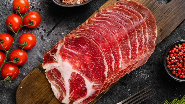 Sliced coppa on a wooden board