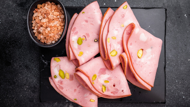 Mortadella slices on a place platter