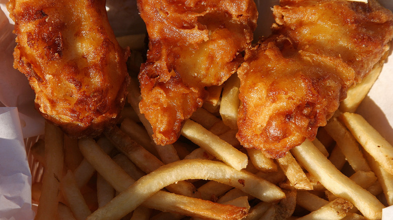 Top view of fried fish with fries