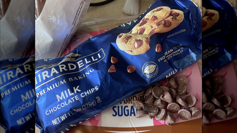 Ghirardelli chocolate chips on top of brown sugar bag on messy counter, mirrored image