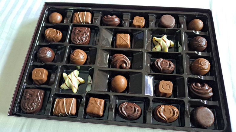Inside of Godiva chocolate box on striped background