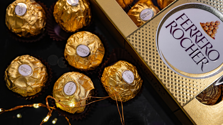 Ferrero Rocher Candies in Original Paper Packaging on Dark Background