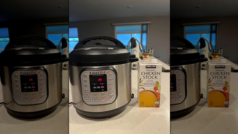 Carton of Kirkland Signature Organic Chicken Stock next to an Instant Pot