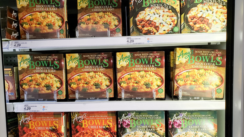 Several variations of Amy's bowls displayed in grocery store freezer case