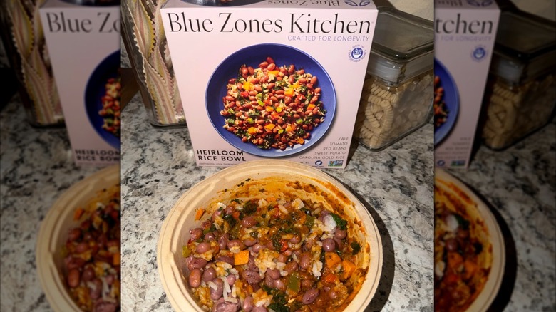 Blue Zones Kitchen heirloom rice bowl alongside prepared meal on kitchen counter