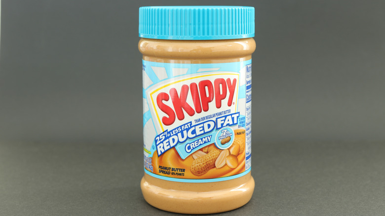 Plastic container of SKIPPY reduced fat peanut butter