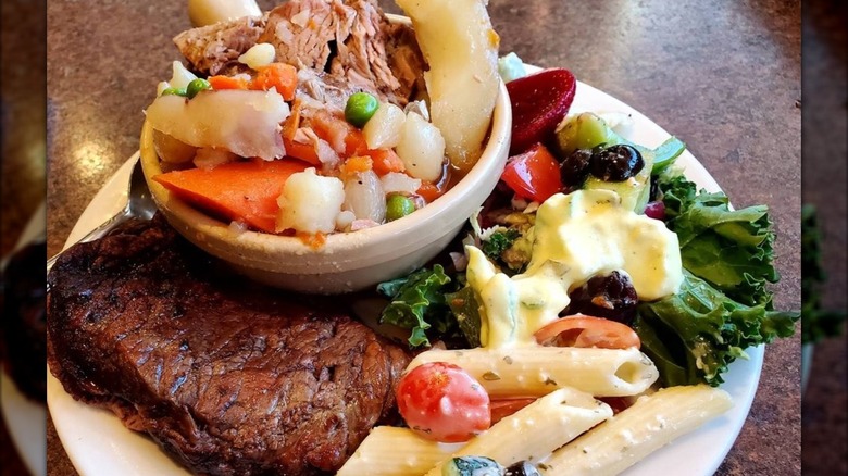 Plate filled with steak and salad at Chuck-A-Rama Buffet