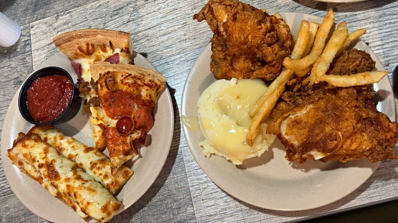 Plates of pizza, fried chicken, and fries at the Pizza Ranch buffet