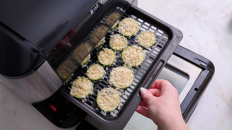 slices of zucchini on air fryer tray